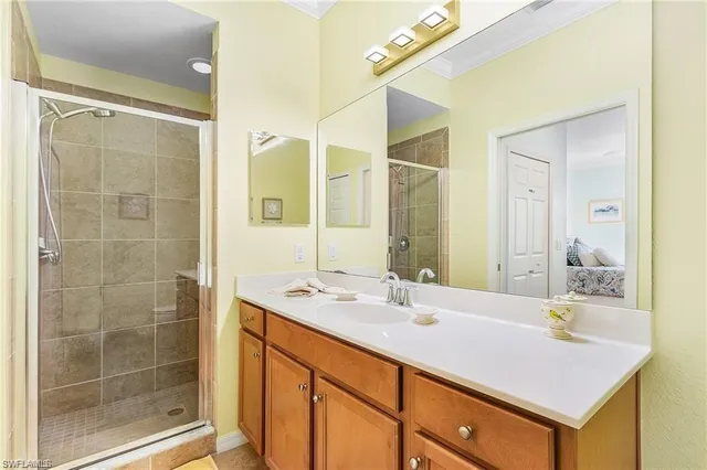 a bathroom with a shower sink and mirror