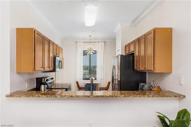 a view of a kitchen with granite countertop cabinets