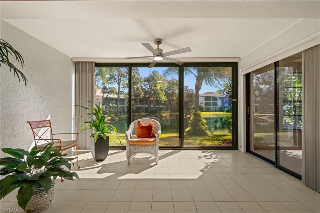 500 Misty Pines Circle, Unit 2103 Naples, FL 34105 - Photo 12 of 38 a living room filled with furniture and large windows