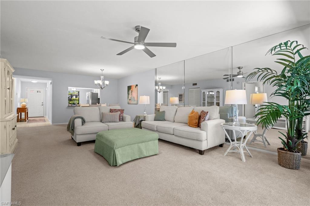 500 Misty Pines Circle, Unit 2103 Naples, FL 34105 - Photo 13 of 38 a living room with furniture and a potted plant