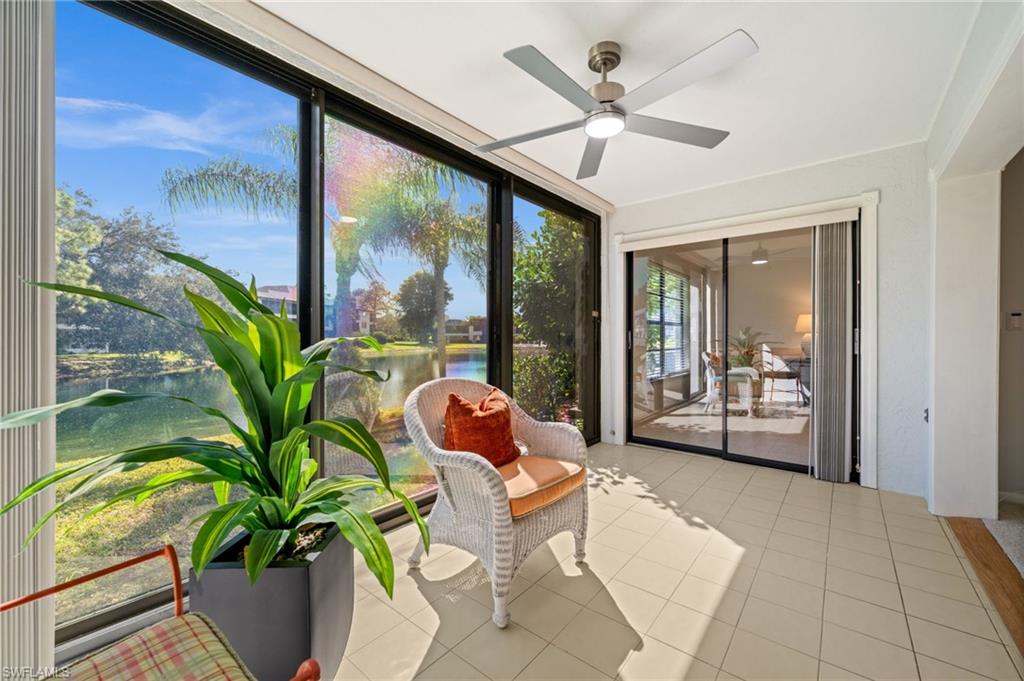 500 Misty Pines Circle, Unit 2103 Naples, FL 34105 - Photo 15 of 38 a living room with patio furniture and a potted plant