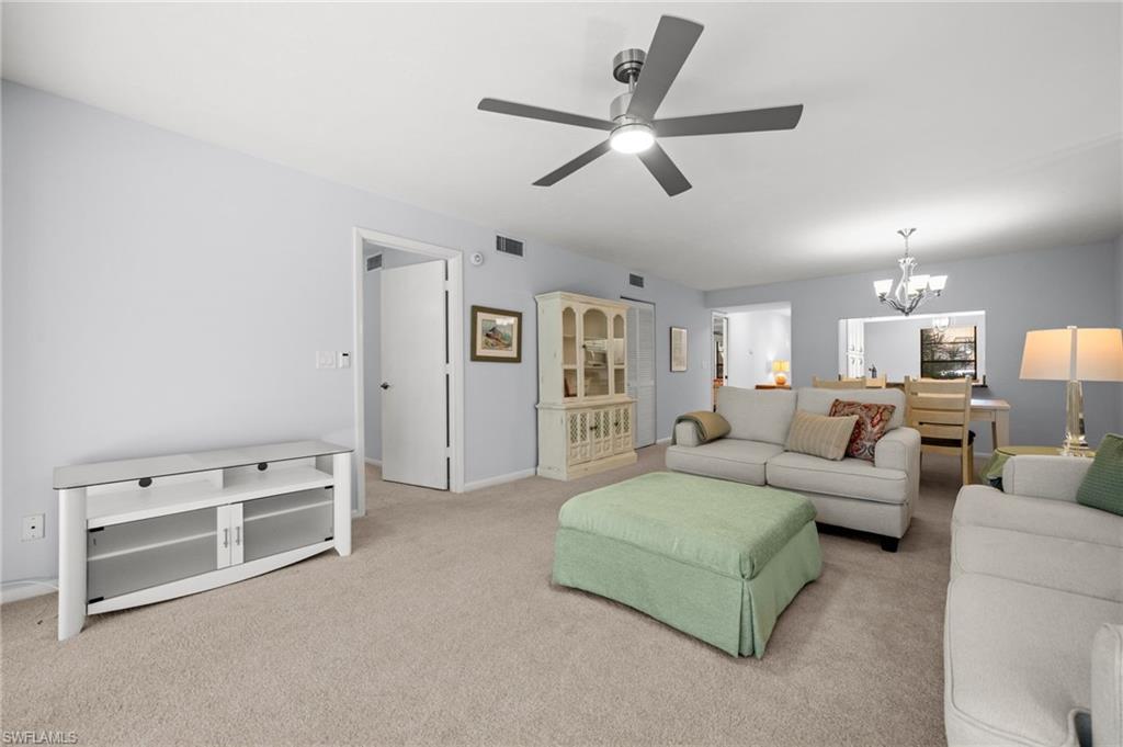 500 Misty Pines Circle, Unit 2103 Naples, FL 34105 - Photo 16 of 38 a living room with furniture and a ceiling fan