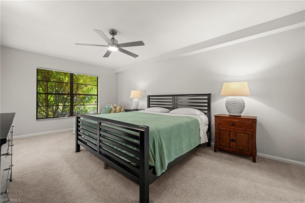 500 Misty Pines Circle, Unit 2103 Naples, FL 34105 - Photo 17 of 38 a bedroom with a bed and window