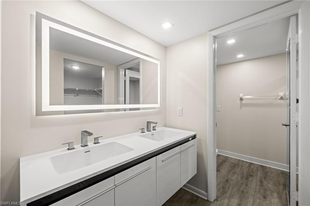 500 Misty Pines Circle, Unit 2103 Naples, FL 34105 - Photo 18 of 38 a bathroom with a sink and a mirror