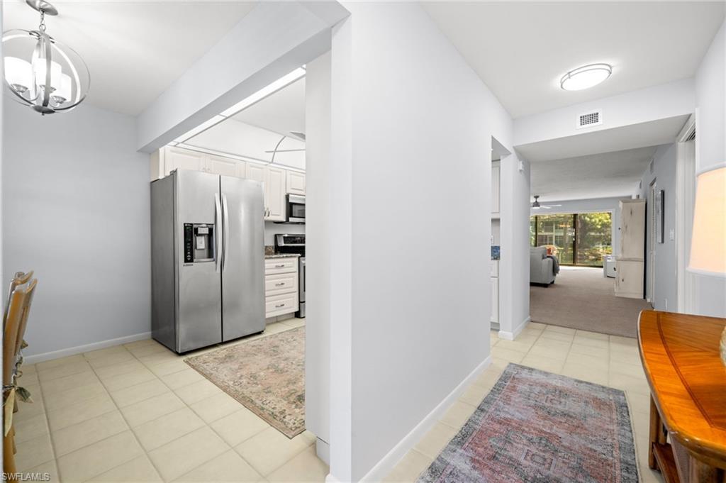 500 Misty Pines Circle, Unit 2103 Naples, FL 34105 - Photo 2 of 38 a view of a hallway view with furniture