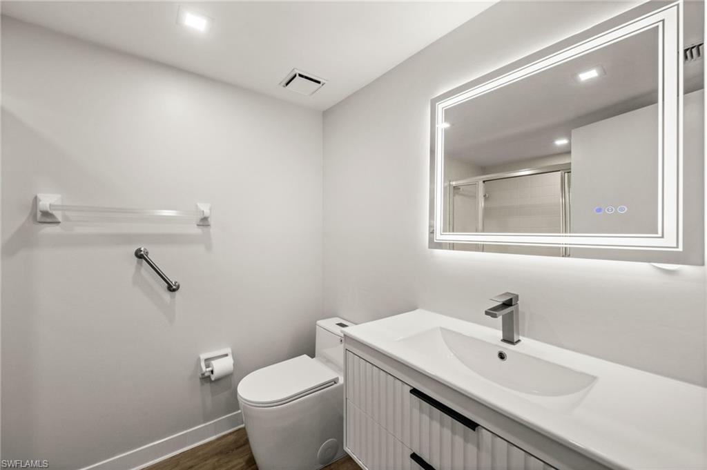 500 Misty Pines Circle, Unit 2103 Naples, FL 34105 - Photo 23 of 38 a bathroom with a sink toilet and mirror