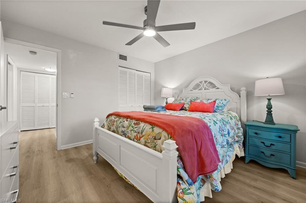500 Misty Pines Circle, Unit 2103 Naples, FL 34105 - Photo 25 of 38 a bedroom with a bed and a dresser