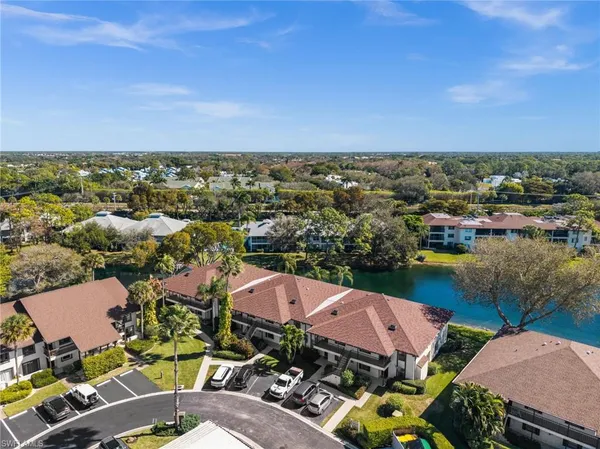 an aerial view of a houses with a lake view