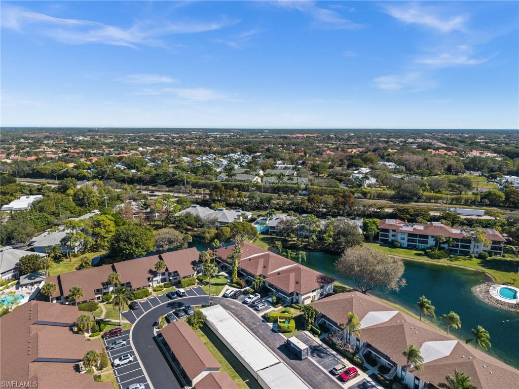 500 Misty Pines Circle, Unit 2103 Naples, FL 34105 - Photo 30 of 38 an aerial view of a city with lake view
