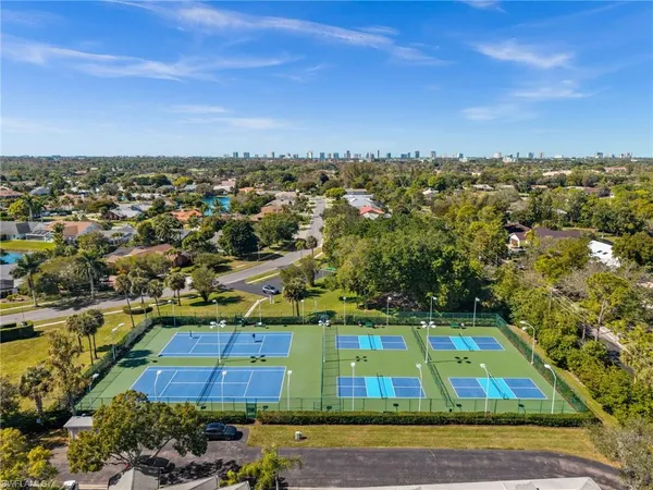 an aerial view of residential houses with yard and swimming pool