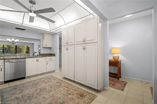a kitchen with white cabinets and white appliances
