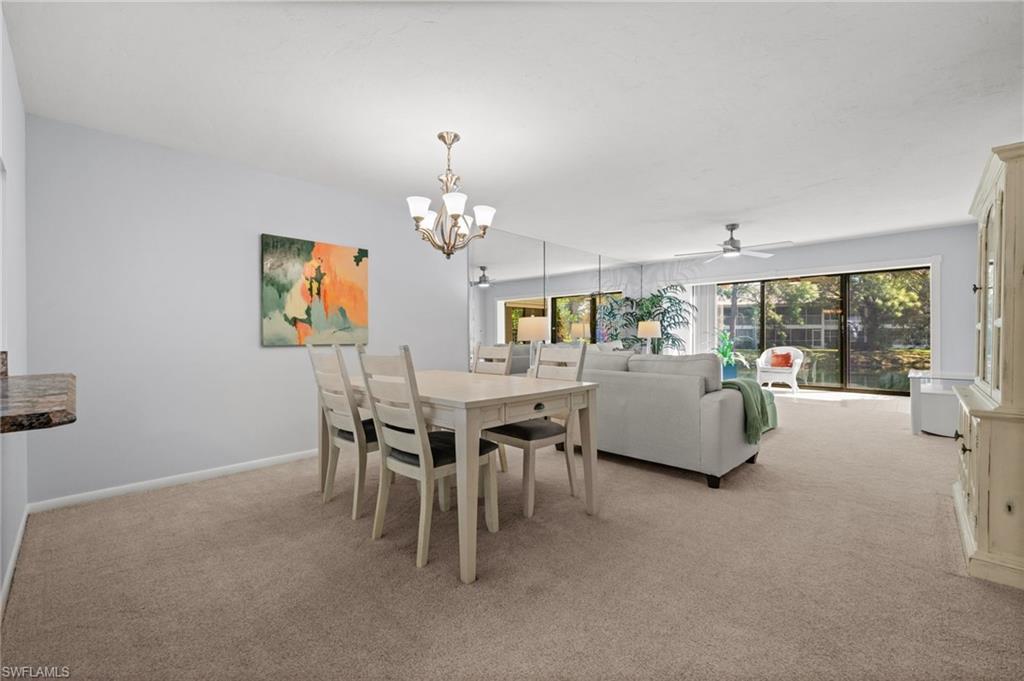 500 Misty Pines Circle, Unit 2103 Naples, FL 34105 - Photo 8 of 38 a living room with furniture and a chandelier