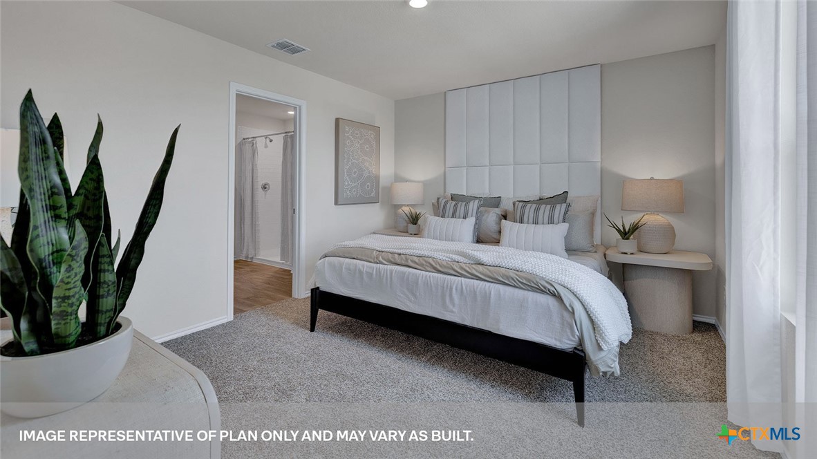 401 Wild Goose Drive Luling, TX 78648 - Photo 24 of 34 a bedroom with a large bed and a potted plant
