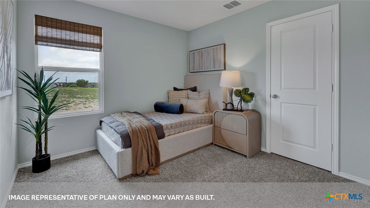 401 Wild Goose Drive Luling, TX 78648 - Photo 9 of 34 a bedroom with a bed and a potted plant