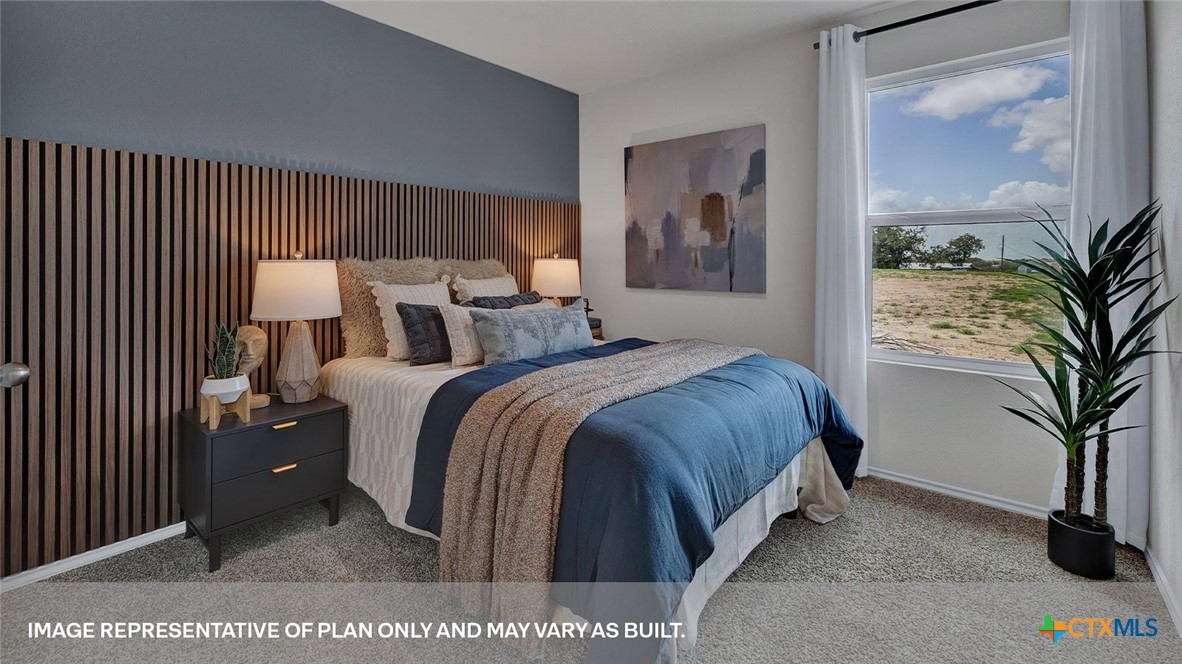 401 Wild Goose Drive Luling, TX 78648 - Photo 10 of 34 a bed room with a bed and a potted plant