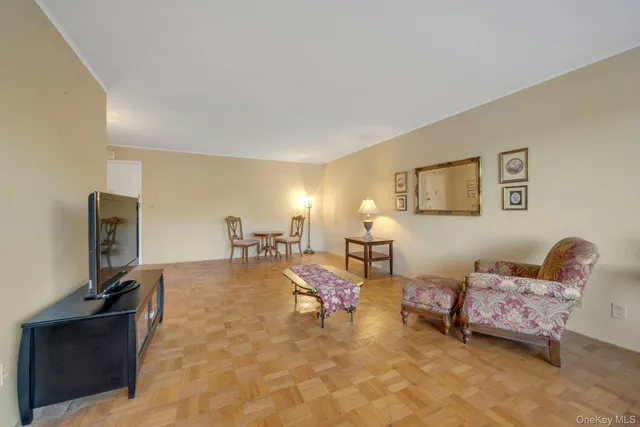 a view of a dining room with furniture a chandelier and wooden floor
