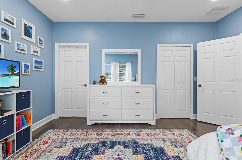 16948 Deer Island Road Tavares, FL 32778 - Photo 33 of 67 a bedroom with a bed and a dresser in it