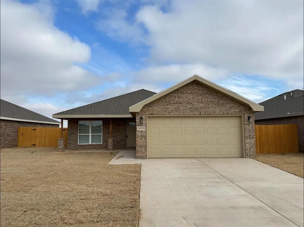 8424 10th Place Lubbock, TX 79416 - Photo 1 of 14 a view of garage and yard