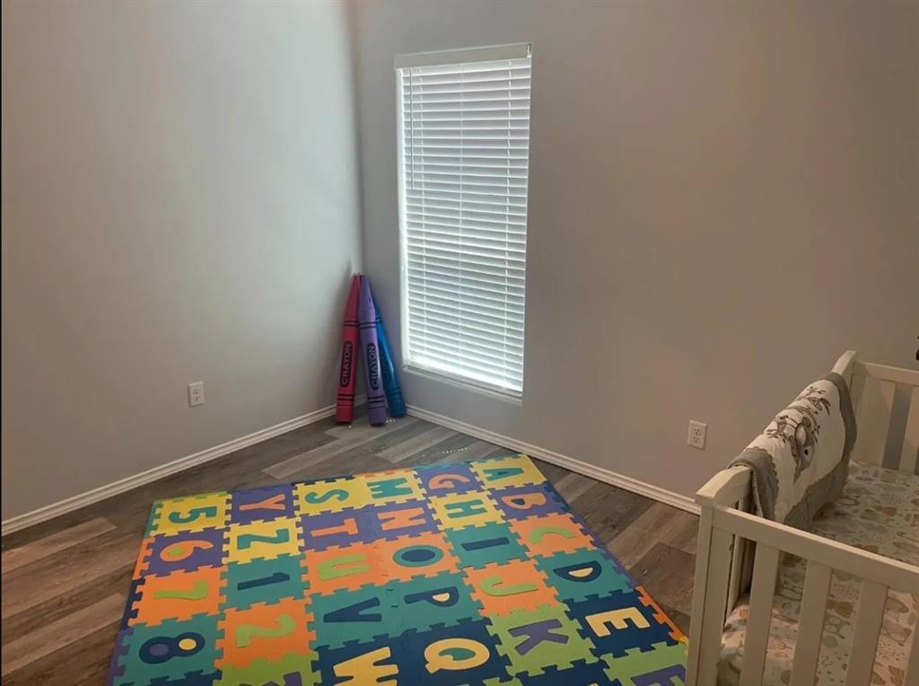 8424 10th Place Lubbock, TX 79416 - Photo 12 of 14 a bedroom with a bed and a window