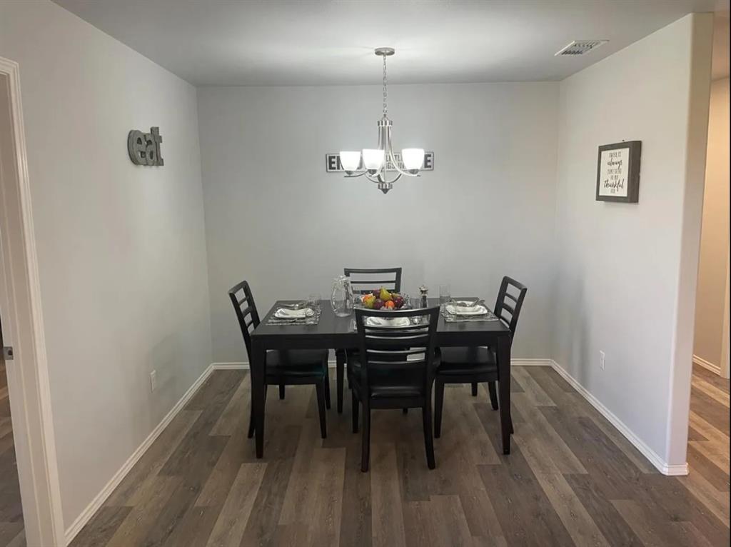 8424 10th Place Lubbock, TX 79416 - Photo 13 of 14 a view of a dining room with furniture and wooden floor