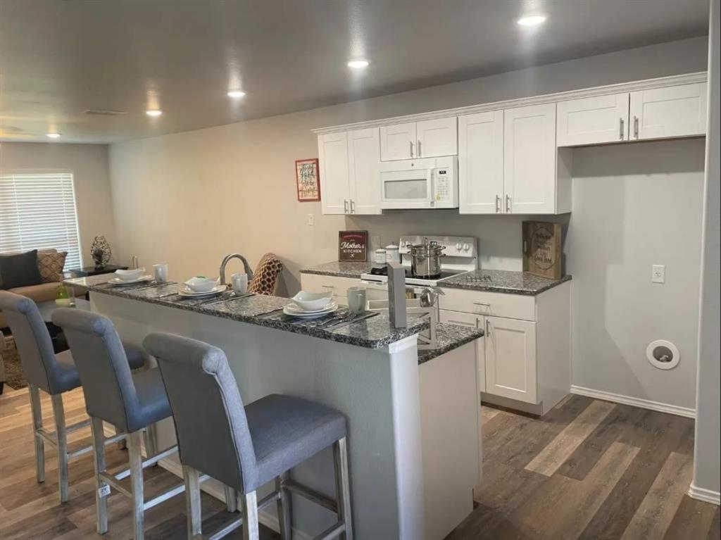 8424 10th Place Lubbock, TX 79416 - Photo 2 of 14 a kitchen with stainless steel appliances granite countertop a sink and cabinets