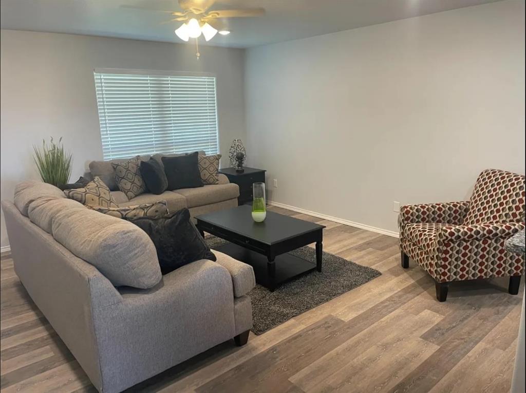8424 10th Place Lubbock, TX 79416 - Photo 5 of 14 a living room with furniture and a lamp