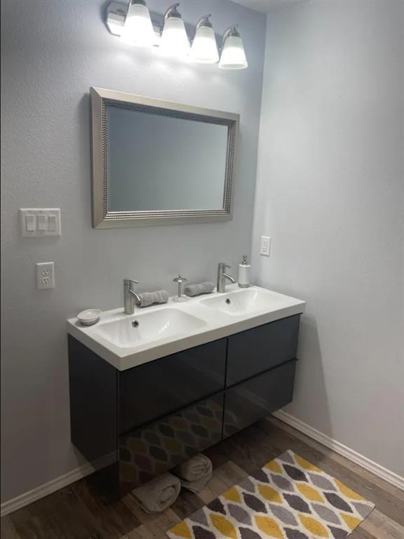 8424 10th Place Lubbock, TX 79416 - Photo 7 of 14 a bathroom with a sink and a mirror