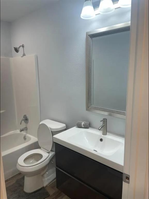 8424 10th Place Lubbock, TX 79416 - Photo 10 of 14 a bathroom with a toilet sink and mirror