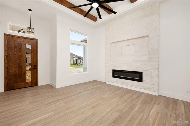 a view of a livingroom with wooden floor and a ceiling fan