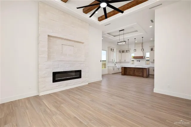 a view of kitchen and kitchen with granite countertop wooden floor
