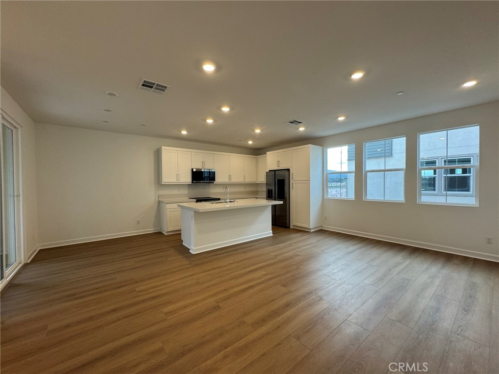 a view of kitchen with wooden floor and windows