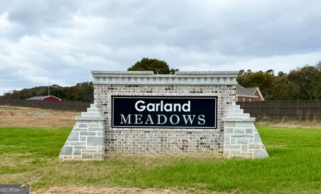 a sign on the side of a lake