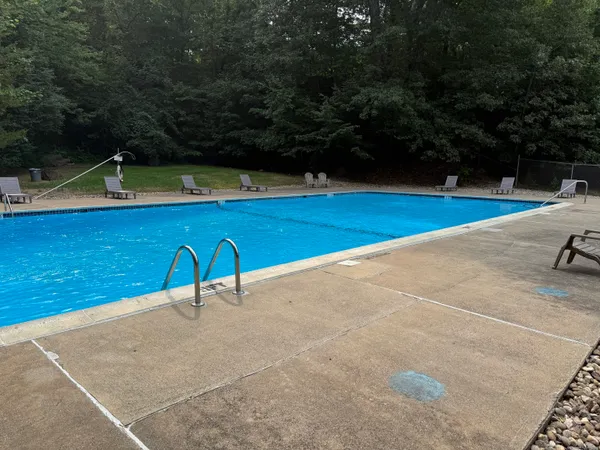 a view of a swimming pool and a yard