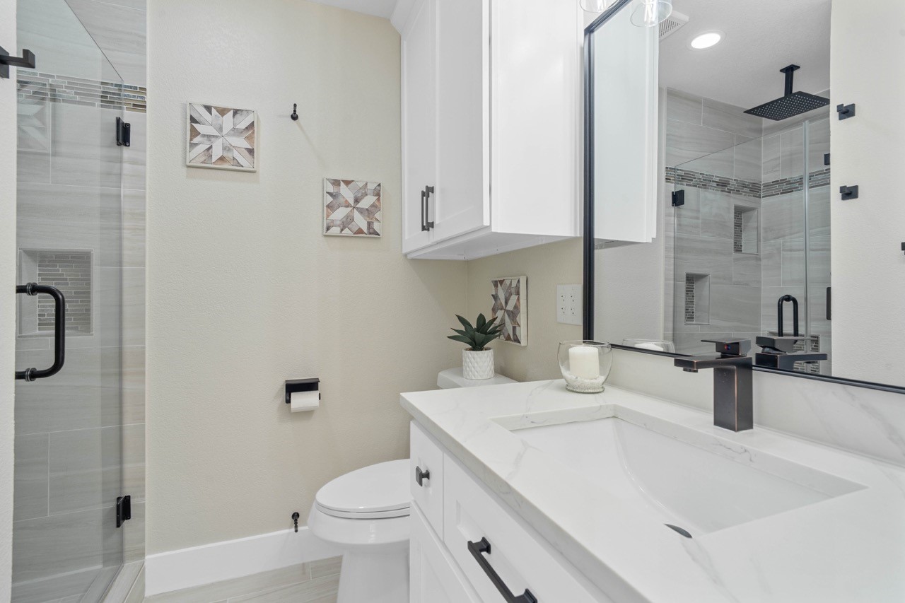 3138 Sunbeam Street Houston, TX 77051 - Photo 37 of 50 Modern elegance shines through every detail, from quartz counters to the designer-inspired glass shower enclosure in the guest bath.