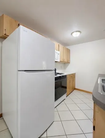 a kitchen with stainless steel appliances a refrigerator and a sink