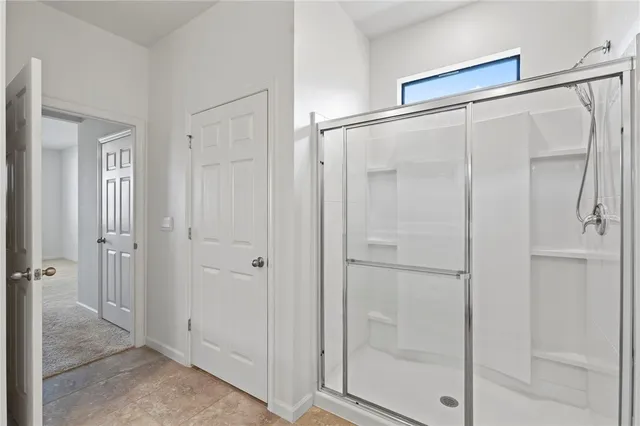 a bathroom with a glass shower door