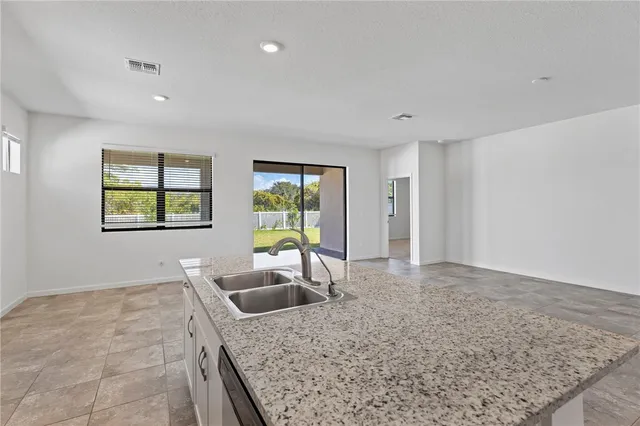 a kitchen with stainless steel appliances granite countertop a sink and a counter top space