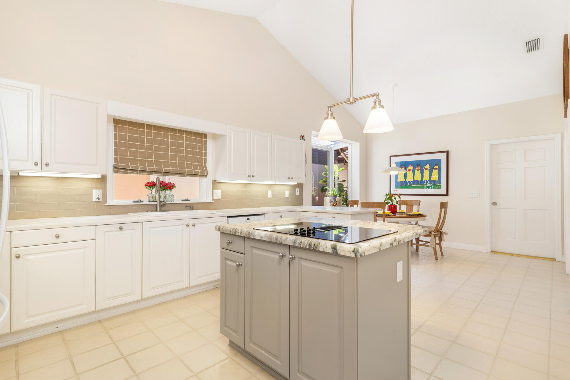 12079 Southeast Birkdale Run Jupiter, FL 33469 - Photo 14 of 50 a kitchen with a sink stove and cabinets