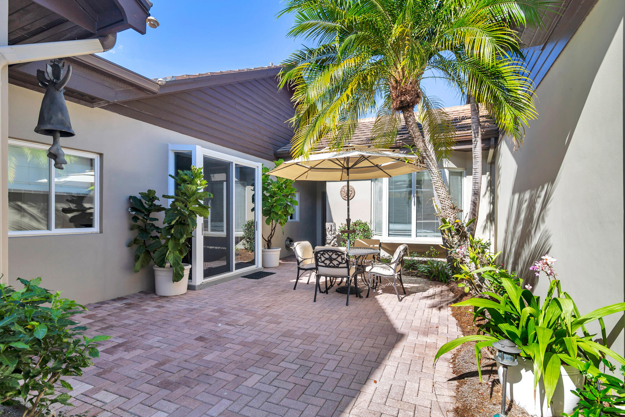 12079 Southeast Birkdale Run Jupiter, FL 33469 - Photo 29 of 50 a view of a house with patio and wooden floor