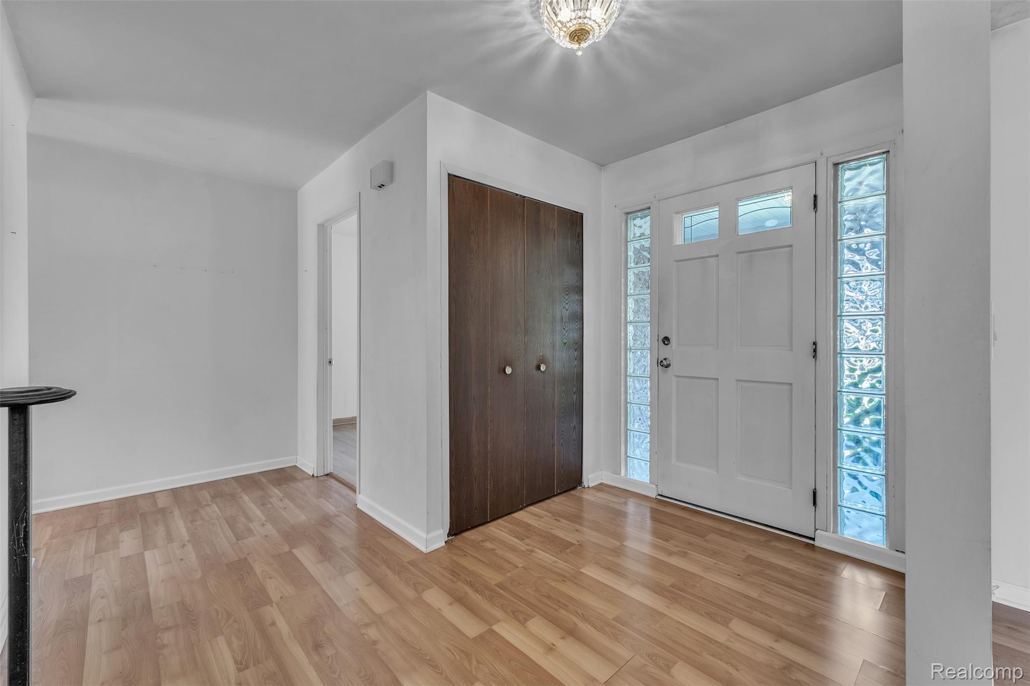 7000 Woonsocket Street Canton, MI 48187 - Photo 6 of 65 Entryway featuring a white paneled door with upper glass inserts, flanked by glass block sidelights