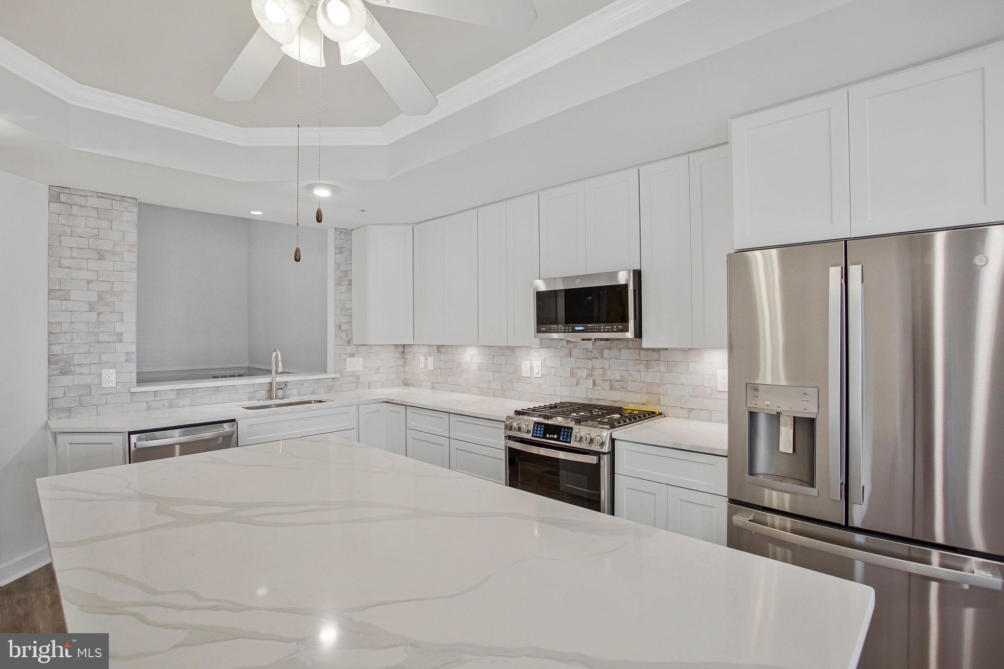322 Hamlet Circle Edgewater, MD 21037 - Photo 4 of 21 a kitchen with stainless steel appliances a refrigerator stove and microwave
