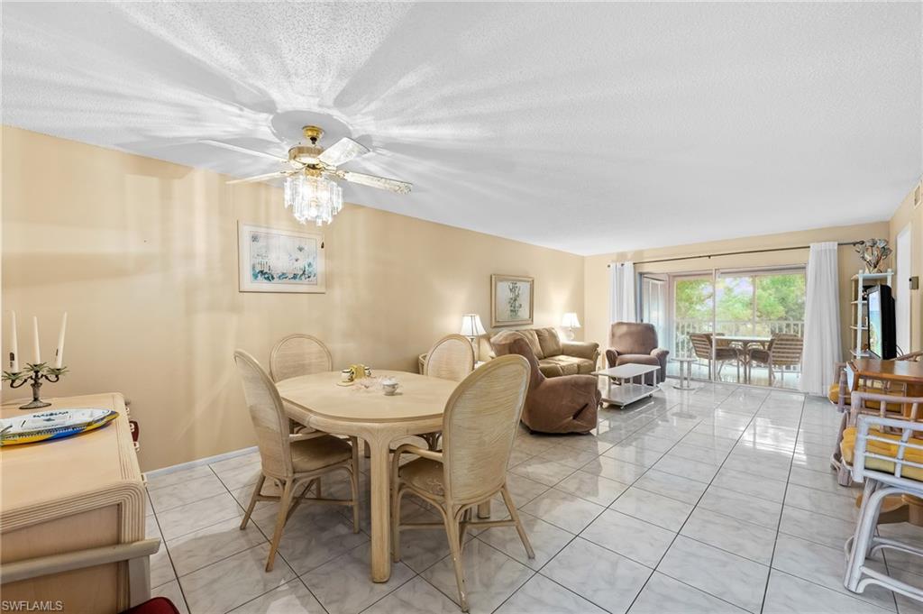 a dining room with furniture and chandelier