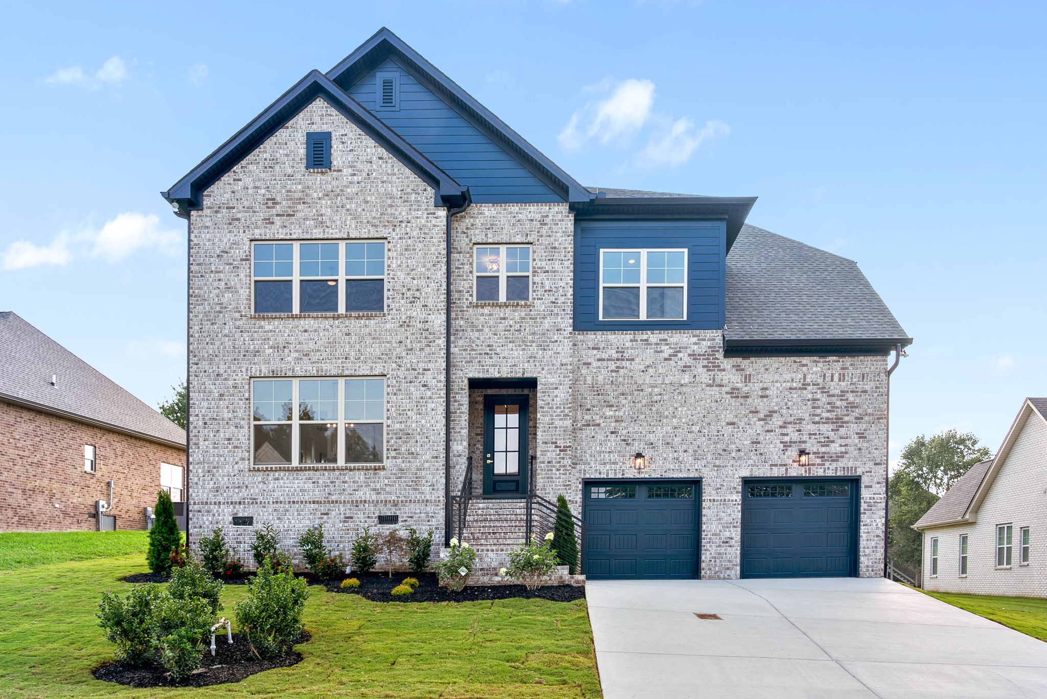 a front view of a house with a yard and garage