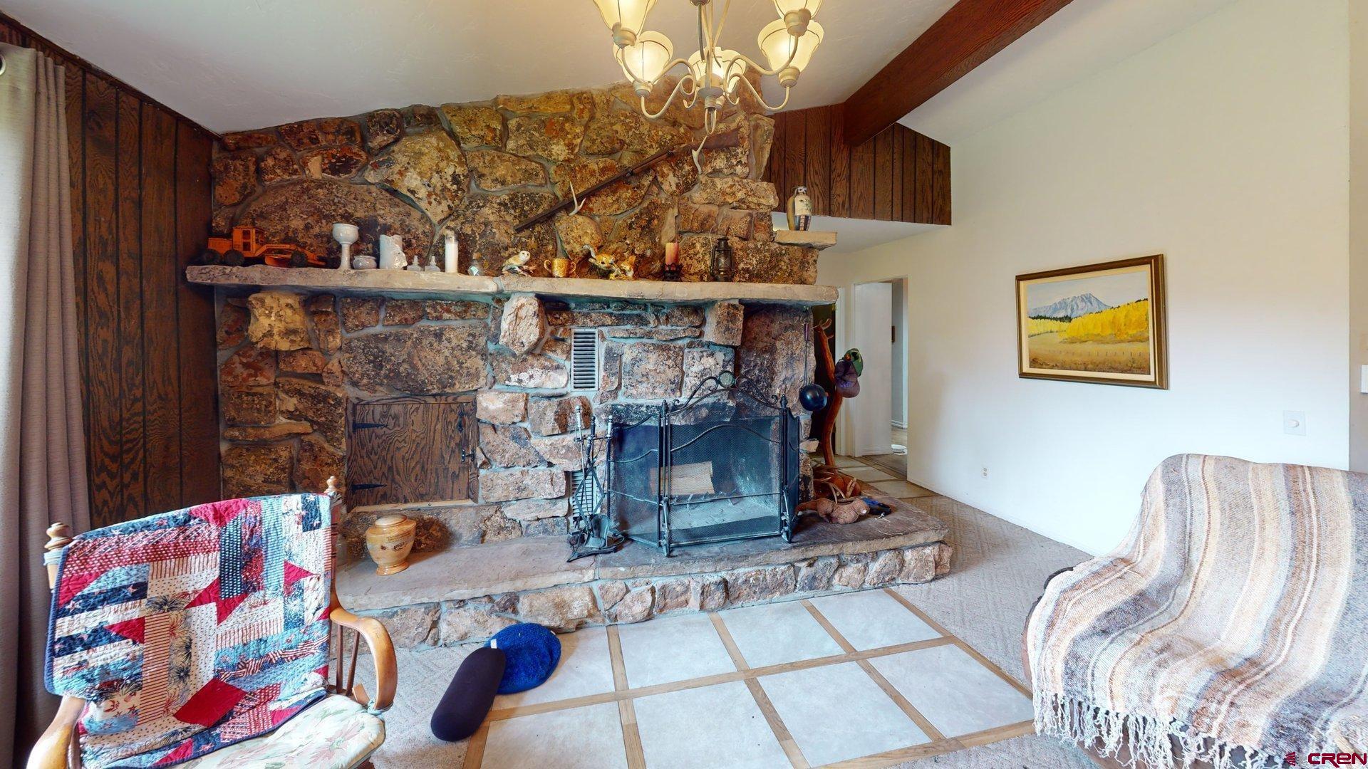 39389 Pitkin Road Paonia, CO 81428 - Photo 7 of 34 Sit back in fornt of the woodburning fireplace with mossrock siding in the vaulted ceilinged living room