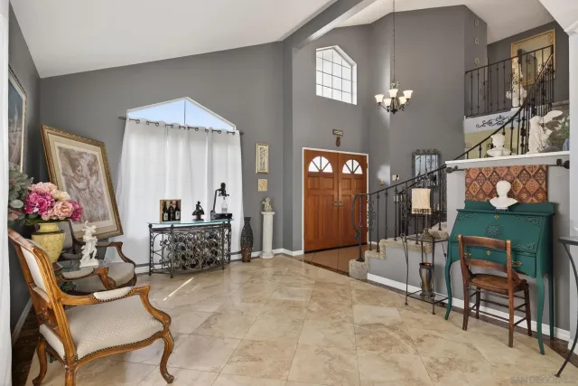 a view of a dining room with furniture a chandelier and wooden floor