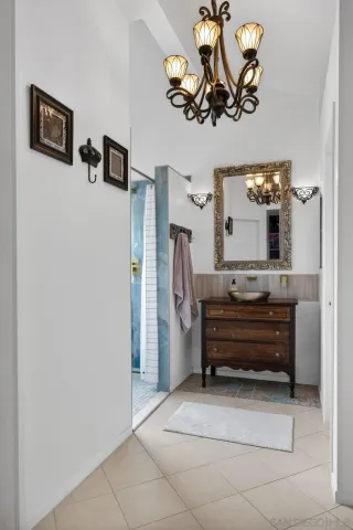 a view of a kitchen with fridge and wooden floor