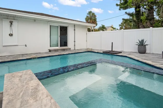 a view of a backyard with jacuzzi