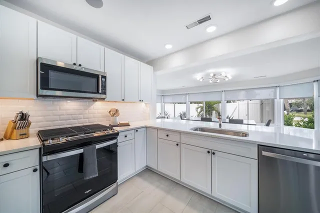 a kitchen with a sink stove and microwave