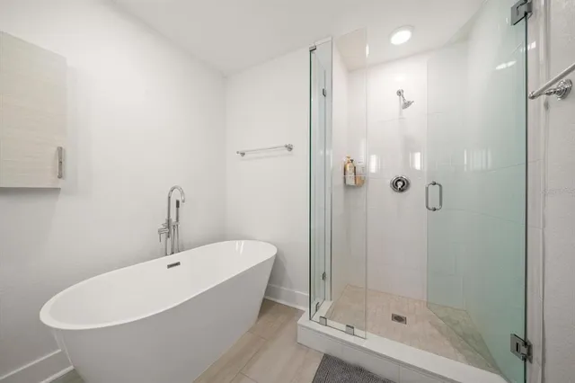 a bathroom with a bathtub and shower
