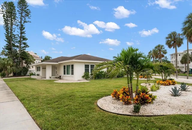 a front view of a house with a garden